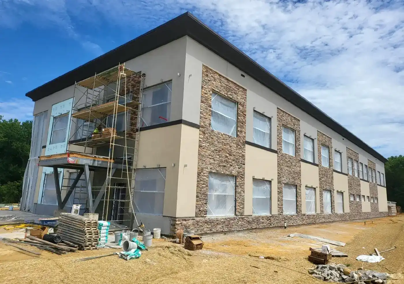 San Antonio Stucco crew finishing a new stucco and stone exterior on a two-story commercial building